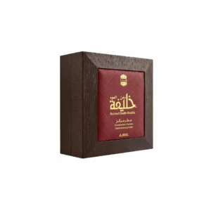 Ajmal Dahnul Oudh Khalifa Concentrated Perfume Oil 3ml attar bottle on a dark luxurious surface with oudh chips